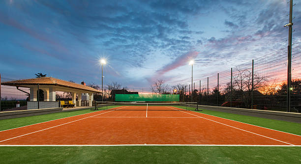 Imaginez une partie de tennis sur un terrain parfait, dans l'emplacement de votre choix. C'est la vision que nous vous proposons de concrétiser avec notre service de construction de terrains de tennis. Que vous ayez besoin d'un court pour un club professionnel, une installation communautaire, ou votre propre jardin privé, notre équipe dévouée est prête à vous fournir un service de qualité inégalée. Chez notre service de construction, nous nous engageons à offrir une conception sur mesure qui répond à vos besoins spécifiques. Grâce à notre expertise acquise au fil des années, nous savons que chaque projet est unique et mérite une attention particulière. C'est pourquoi nous travaillons de manière méthodique pour intégrer toutes les caractéristiques spécifiques dont vous avez besoin dans votre projet. Nous nous efforçons de fournir des terrains de tennis de la plus haute qualité, qui respectent toutes les normes et réglementations internationales. Nos équipes hautement qualifiées ont une excellente compréhension des diverses surfaces de jeu, y compris le gazon, la terre battue, le dur et le synthétique. Nous veillerons à ce que la surface de votre court de tennis soit adaptée à votre style de jeu, à votre environnement et, bien sûr, à votre budget. Nos spécialistes s'occupent de tout, de la planification à la réalisation, en passant par la mise en œuvre des travaux de construction et l'installation d'éclairages, de clôtures et d'autres équipements. Nous prenons également en charge l'entretien de votre terrain, pour vous assurer une durabilité et une performance optimales. Faites de votre rêve une réalité avec notre service de construction de terrains de tennis. Où que vous soyez, quelles que soient vos exigences, nous sommes prêts à vous offrir une solution qui répondra à vos attentes. Contactez-nous dès aujourd'hui pour discuter de votre projet et commencer votre parcours vers la création du terrain de tennis parfait.