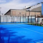 a tennis court with a blue tarp on it