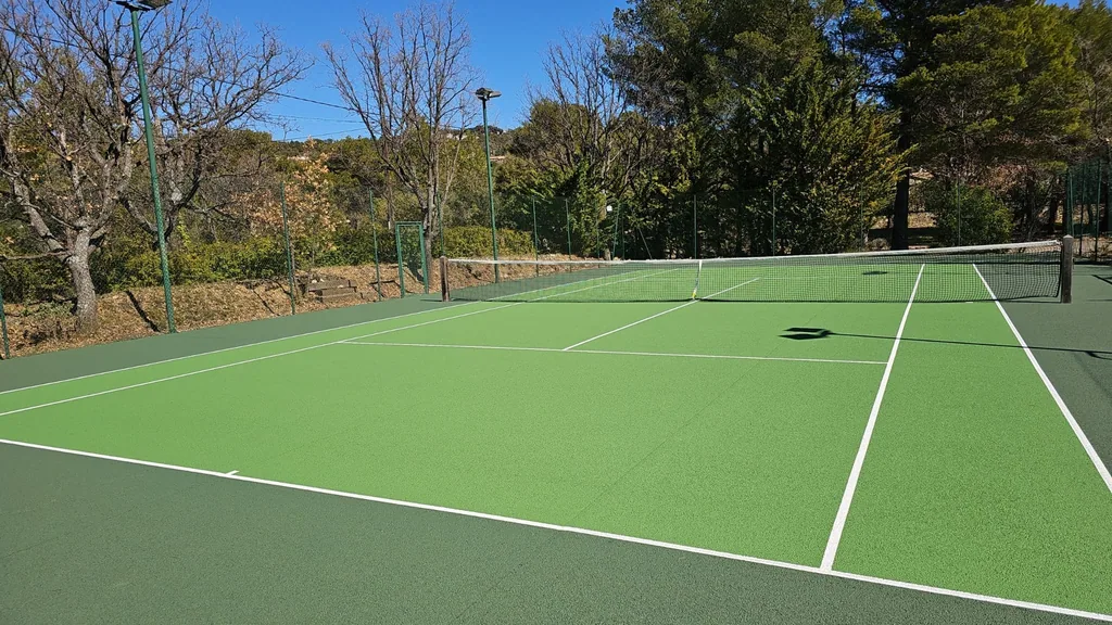 Court de tennis vert dans un jardin méditerranéen
